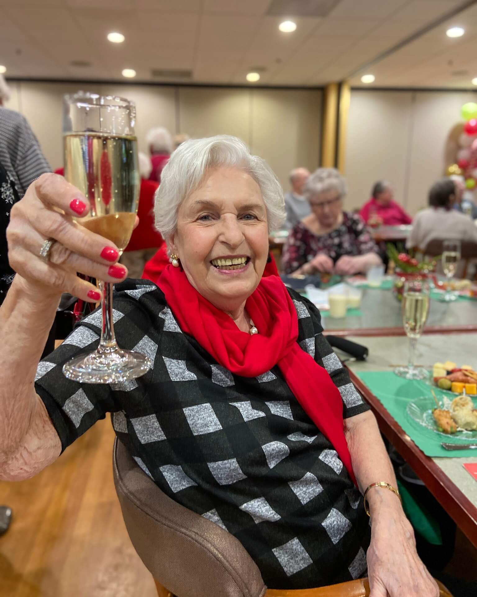 267674997_4853957394637831_1410438463521750645_n senior woman raising her glass