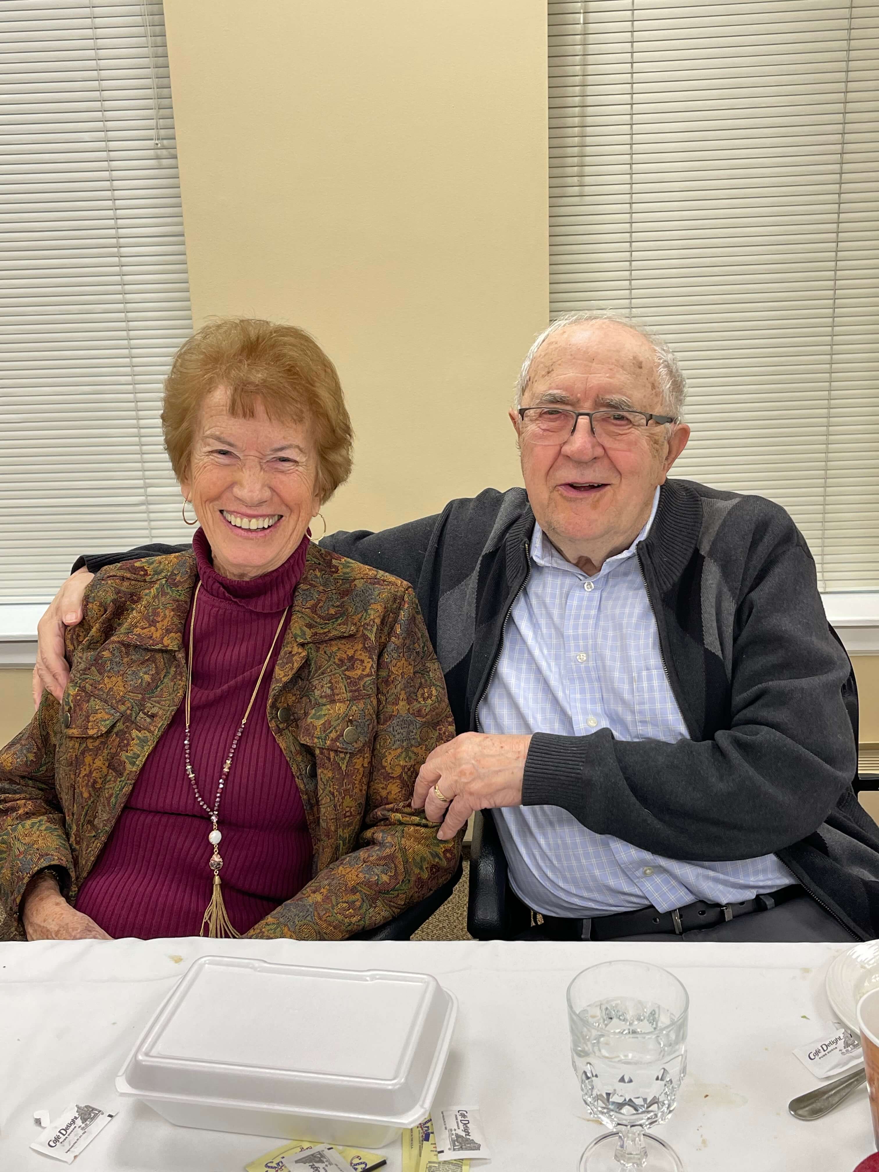senior couple smiling together at a community event