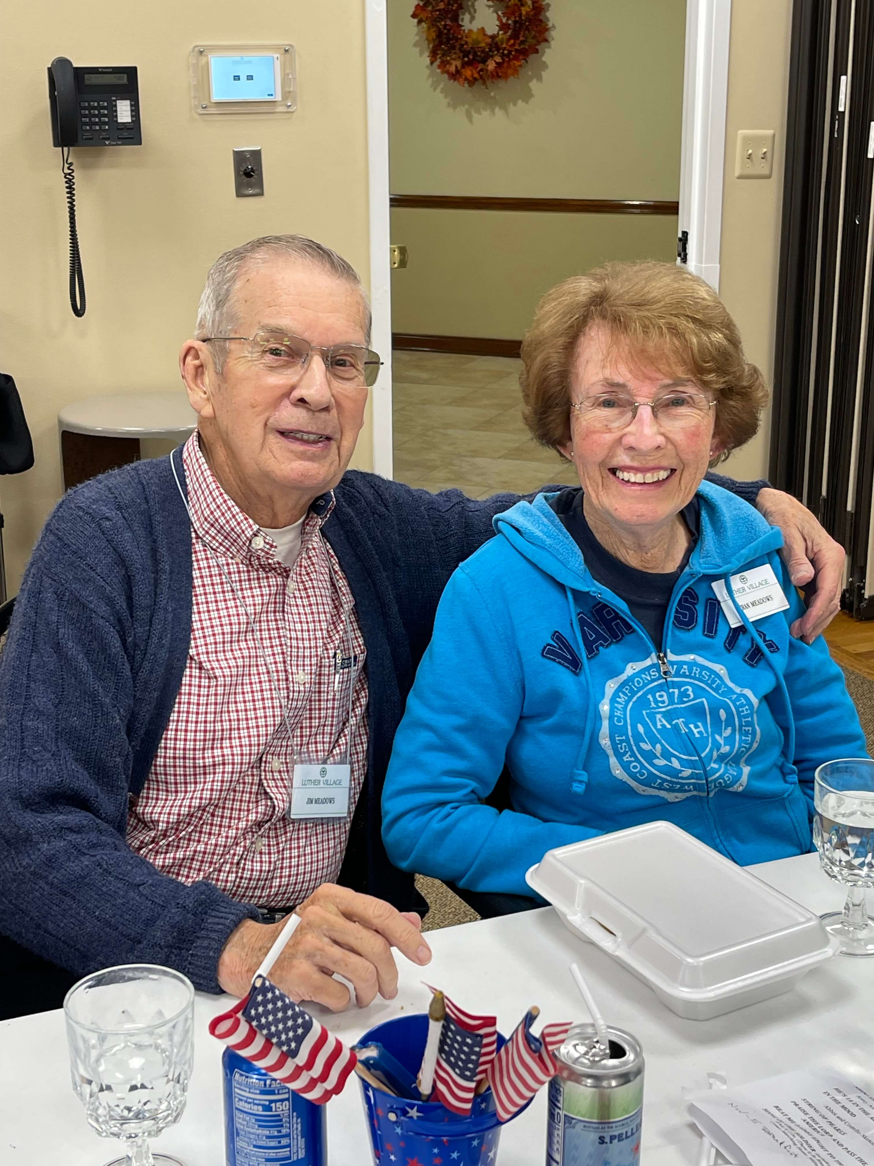 senior couple smiling together at a community event