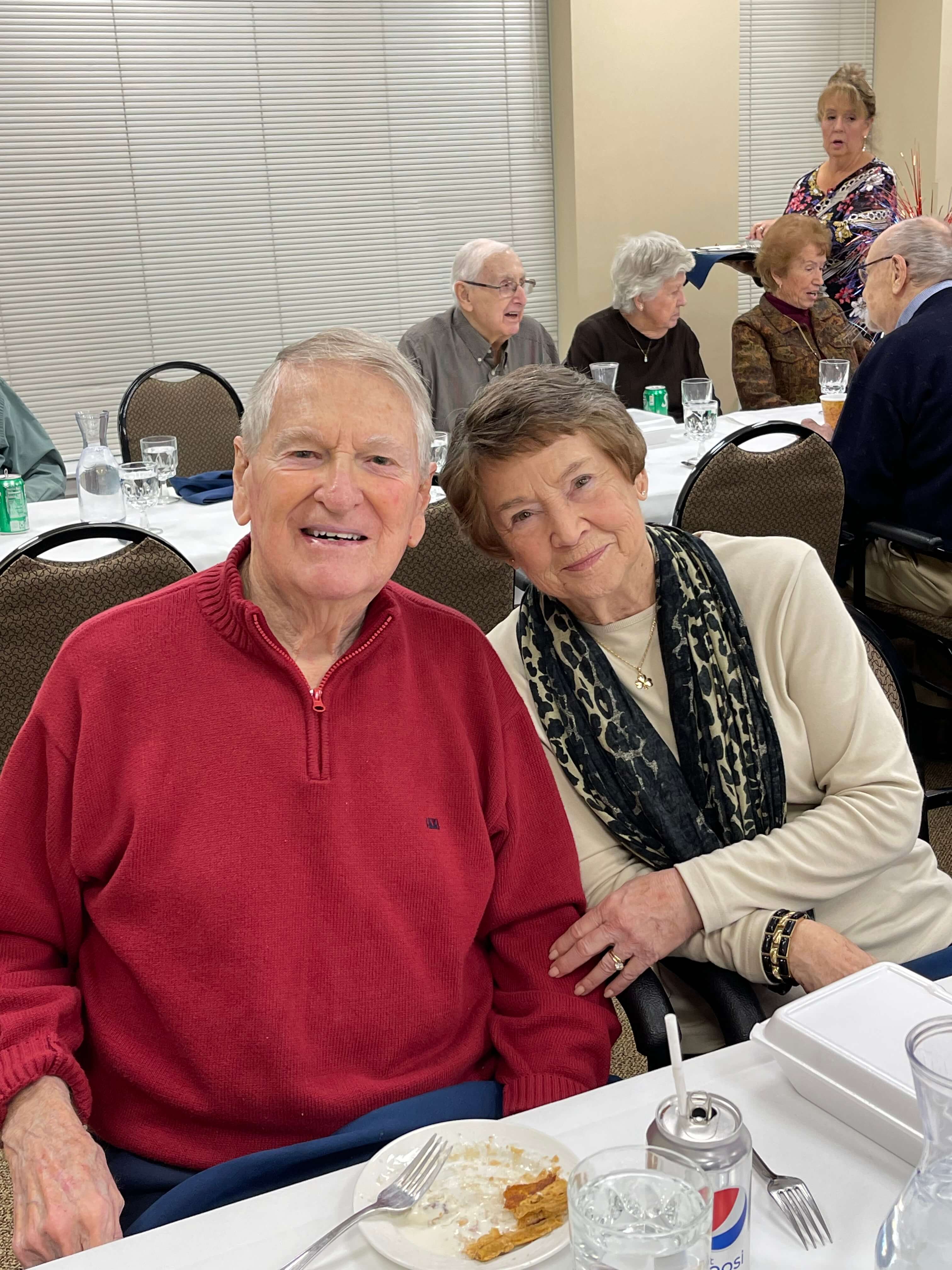 senior couple smiling together at a community event