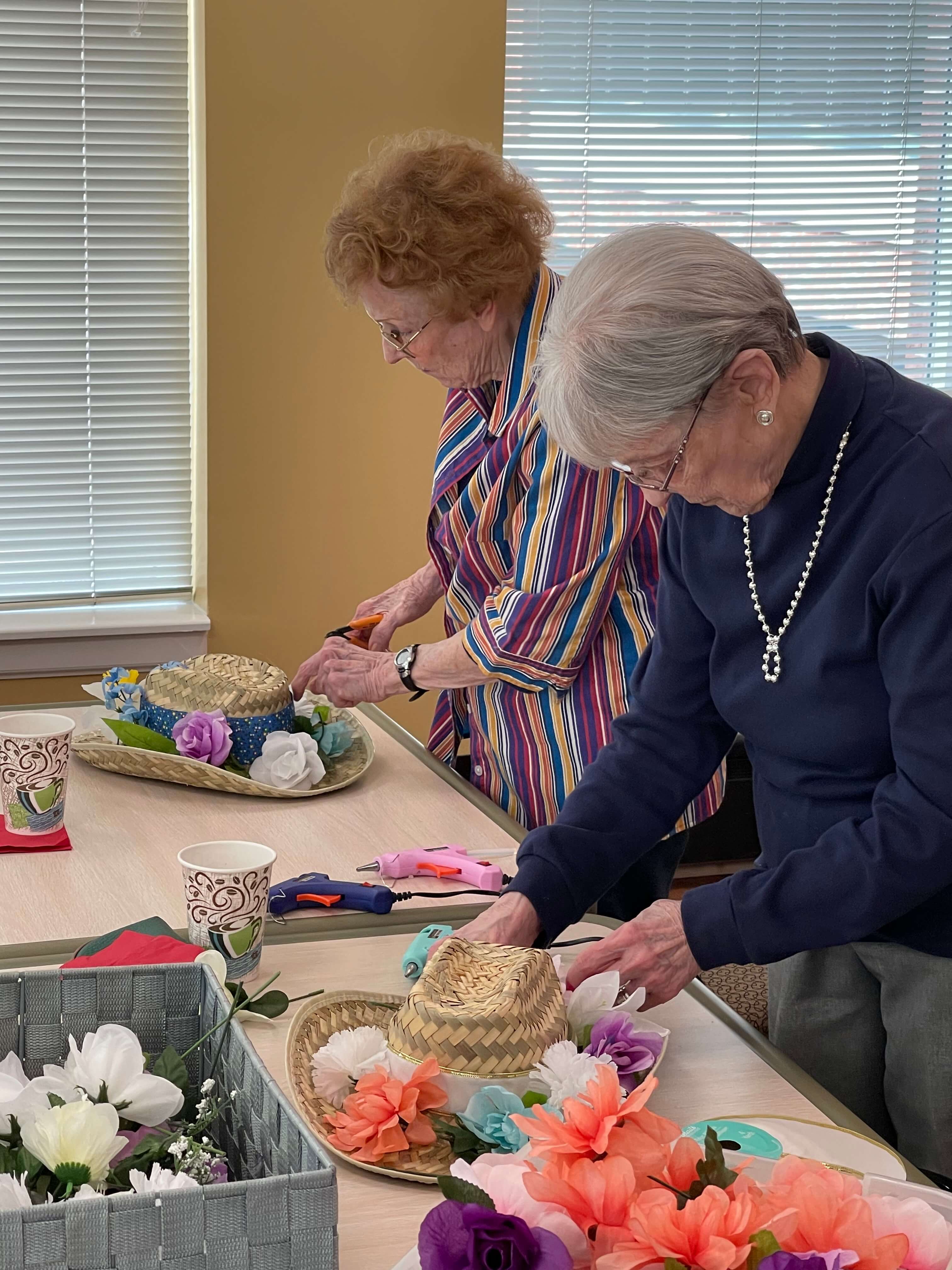senior women decorating hats