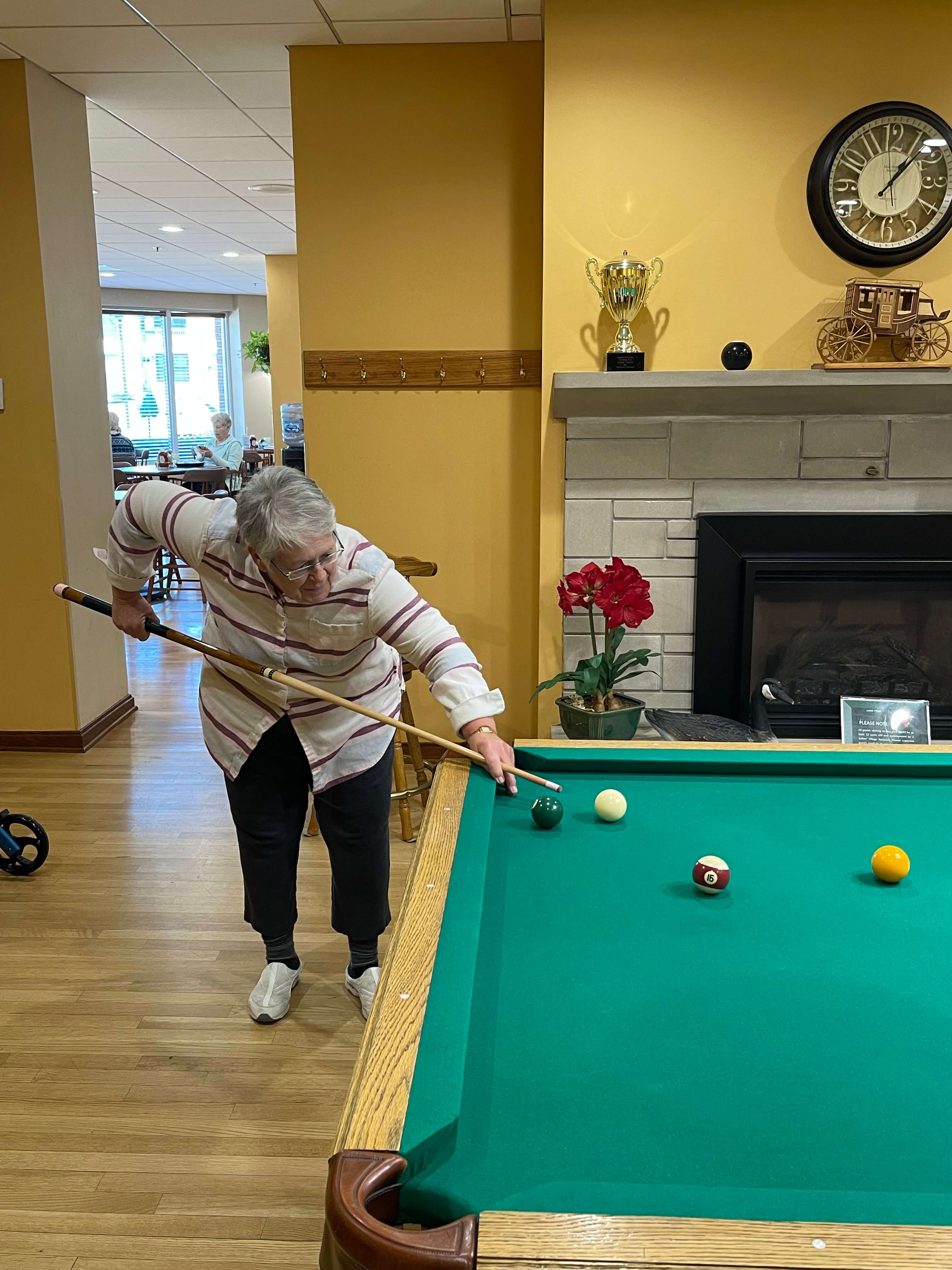 senior woman playing pool